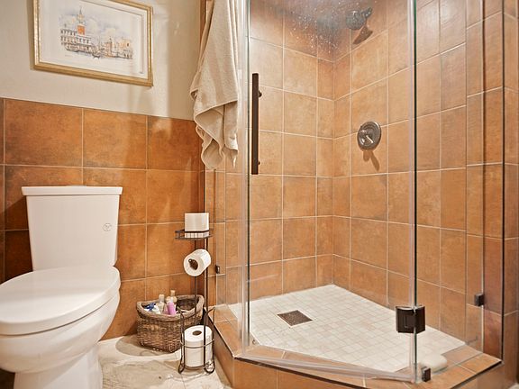 bathroom area with corner shower.