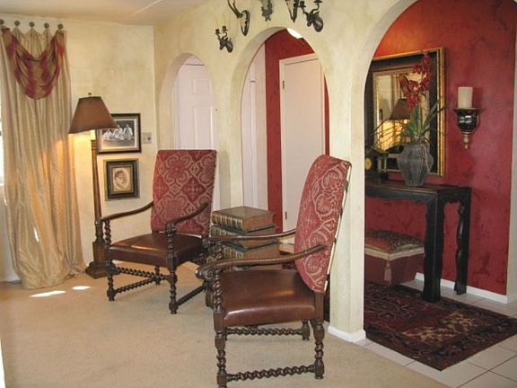 Tiled entry with closet and stylish archways 