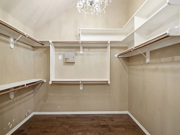 Deep Walk In Closets with Custom Built Ins