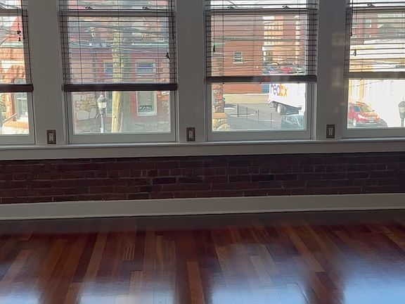six foot windows that flooded the apartment with light. With wooden blinds.