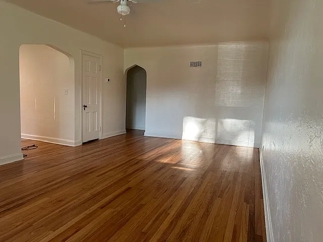 Living Room 12' x 19'
left entry to kitchen/eating nook 
ceiling fan, window A/C