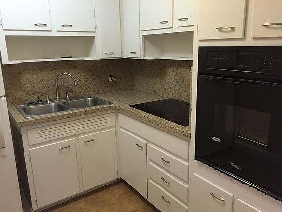 Kitchen with new stove top and wall oven