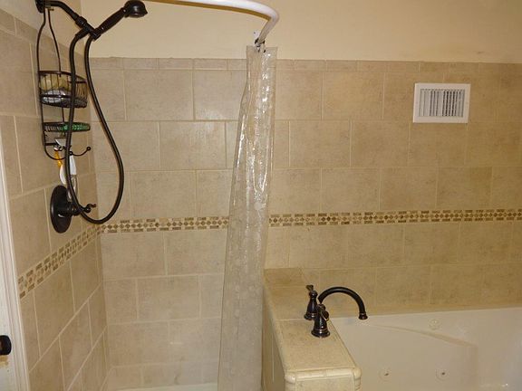 Shower by bathtub