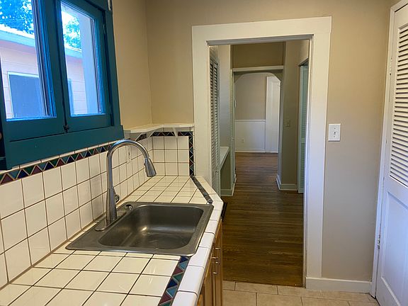 Hallway into the tiled kitchen.