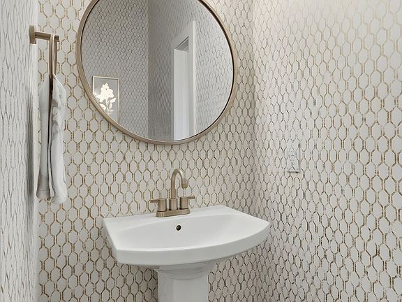 Conveniently located main-floor half bath sits between the living room and kitchen.
