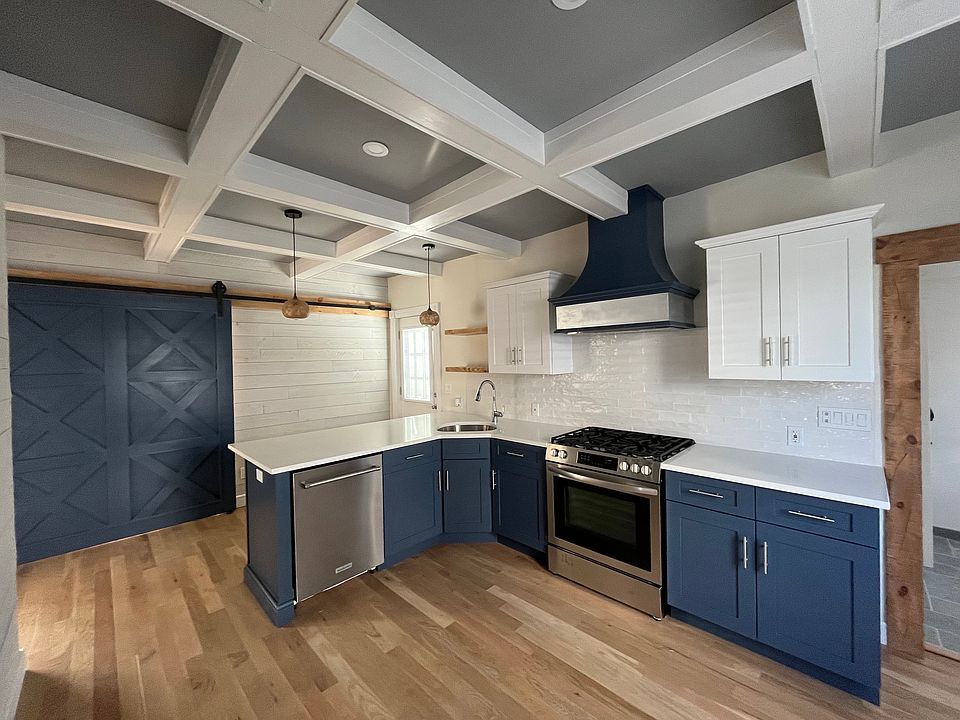 Kitchen with Coffered Ceiling, Quartz Counter Top, Custom Built Range Hood, Stainless Steel Gas Range, Dishwasher and Refrigerator, Rustic Beams, Floating Shelves and a Wine Bar!
