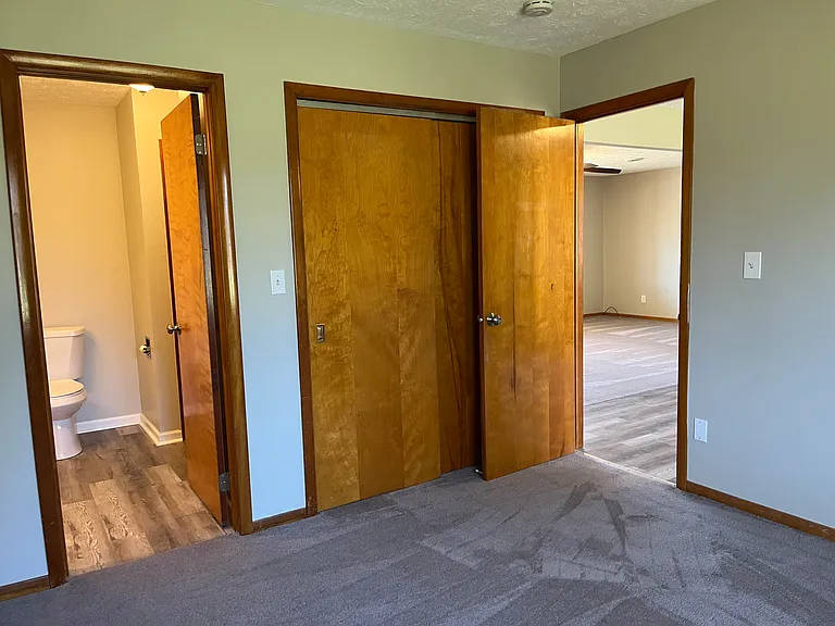 Bedroom with jack-and-jill bathroom and view to living room and kitchen