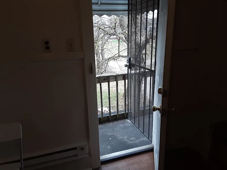 kitchen leading to small deck and stairway into backyard