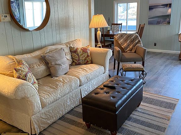 Living area next with couch and separate dining table/chairs on main living floor.