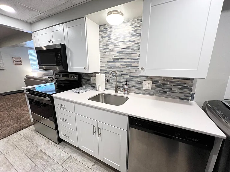 Kitchen with large deep sink, Microwave, and dishwasher