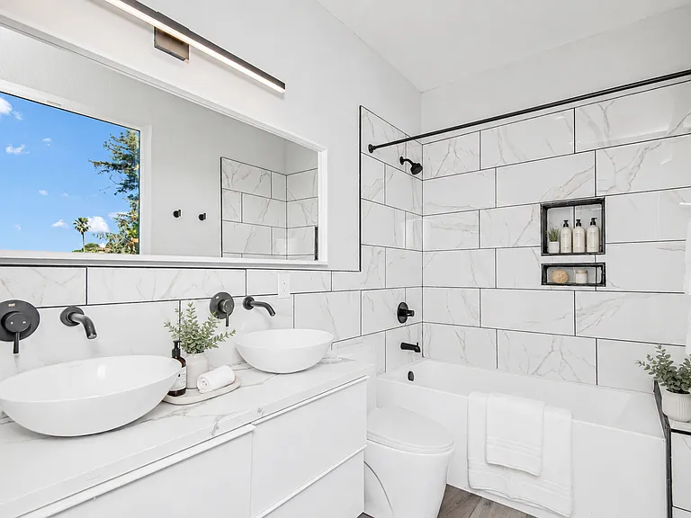 Master bathroom features his and her vanity, soaking tub