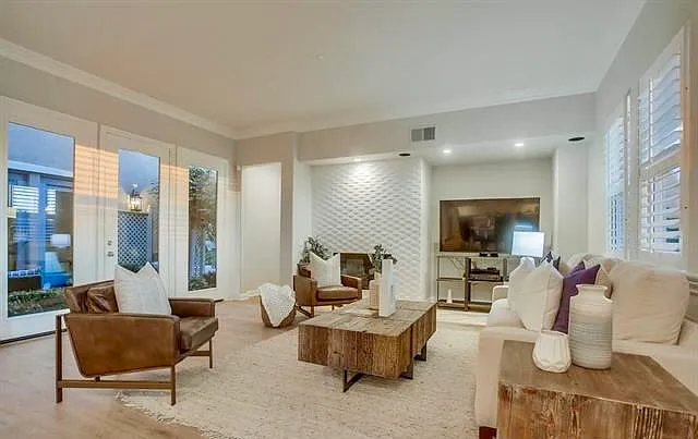 Living room with fireplace and backyard golf course and ocean views