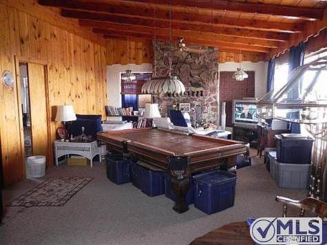 greatroom type living room with open beamed ceilings