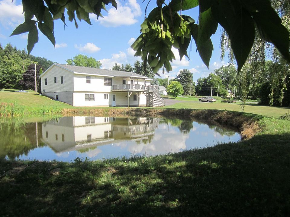 The house from the back yard. The pond is a work in progress.
