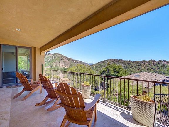Upper balcony with Adirondack chairs and potted plants _ ideal for morning coffee