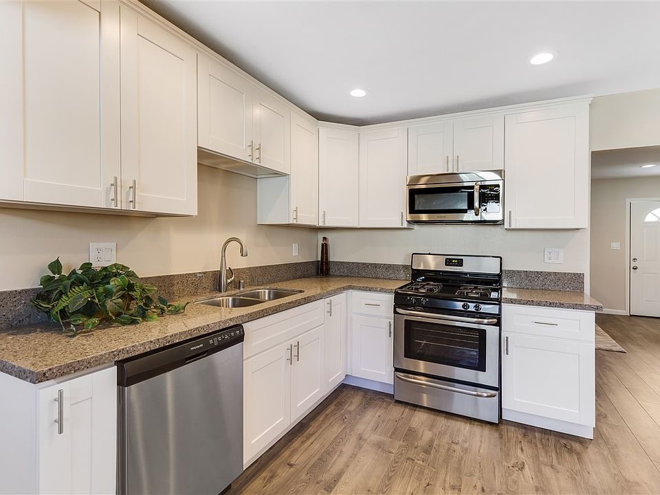 New custom kitchen with beautiful quartz counter tops, new floors & stainless steel appliances.