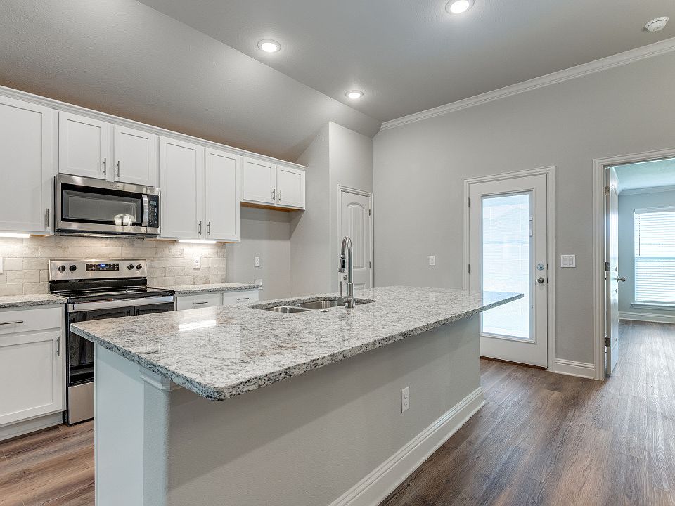 Modern open-plan kitchen with updated appliances.