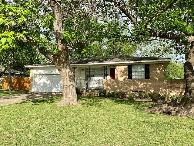 Front exterior with front entry driveway and front porch.