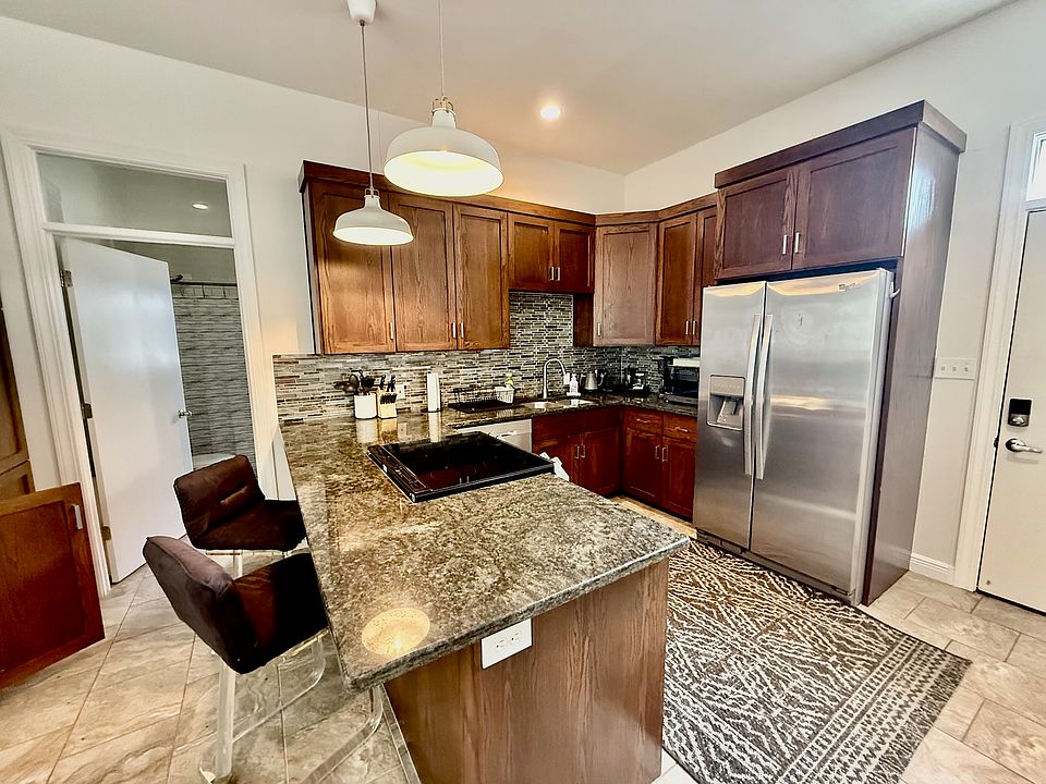 Kitchen with all stainless appliances including a dishwasher, electric oven/stove and granite countertops