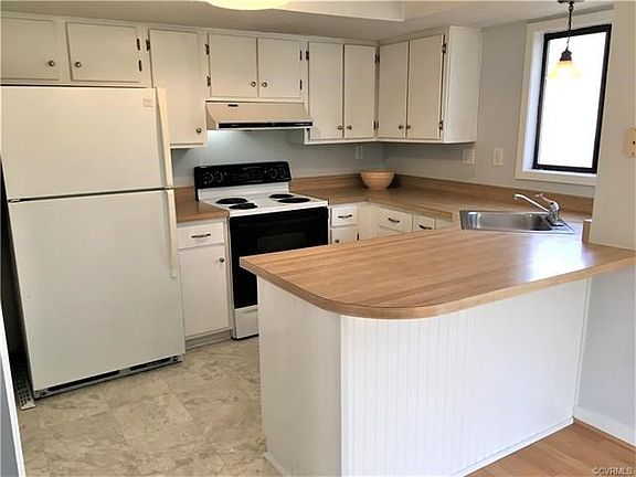 Kitchen has new flooring and refrigerator conveys!