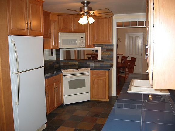 Slate flooring, porcelain countertops, maple cabinets