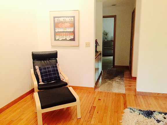 View from living room to the hallway. Stairway to the upper level is to the right.