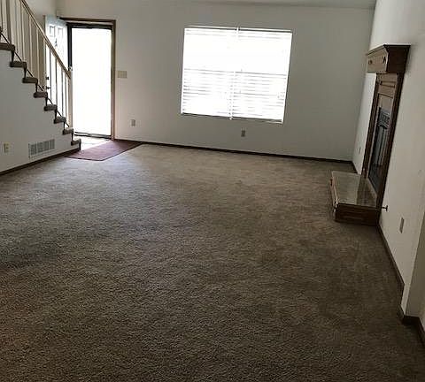Front door and living room with fireplace
