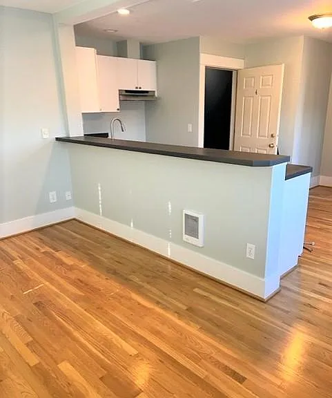 Open kitchen and living room with hardwood floors