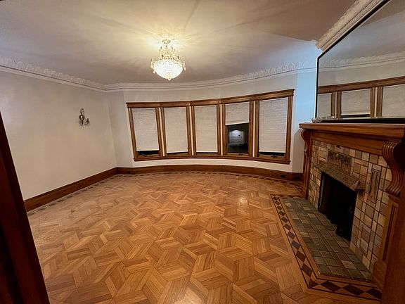 Living room with a fireplace and parquet floors