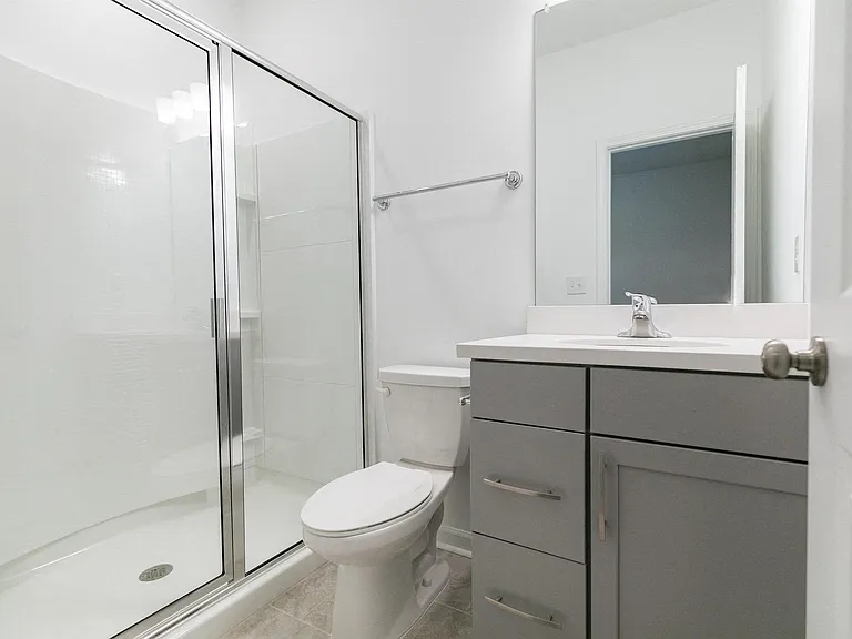 Bathroom including single vanity and walk in shower.