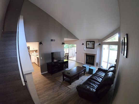 Living room with reclining couch, 55' 4K tv, and coffee table.