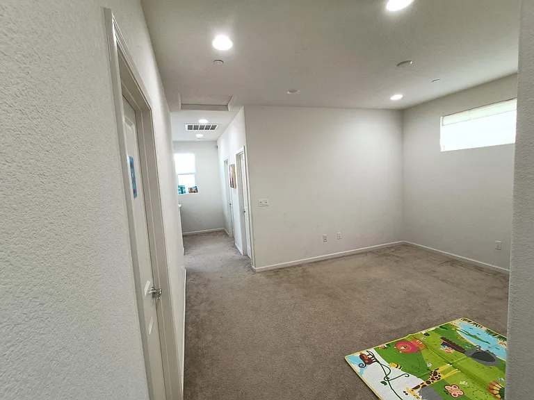 Second-floor walkway, revealing a loft that connects all three bedrooms. This view captures the essence of interconnected living, where each step connects you to comfort and convenience. Welcome to a home where every corner tells a story of warmth and tog