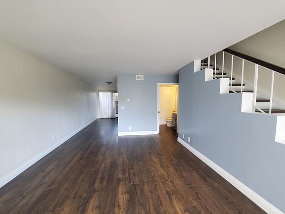 Living area looking back to the 1/2 bathroom, laundry closet, and dining area.