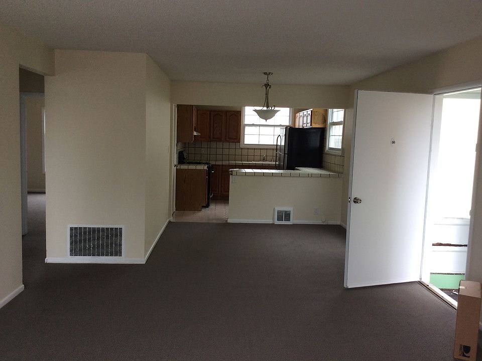 Open concept view from living room to dining space and kitch
