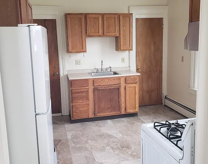 Sink, cupboards, and floor to ceiling pantry