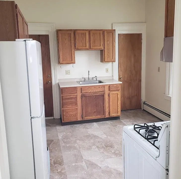 Sink, cupboards, and floor to ceiling pantry