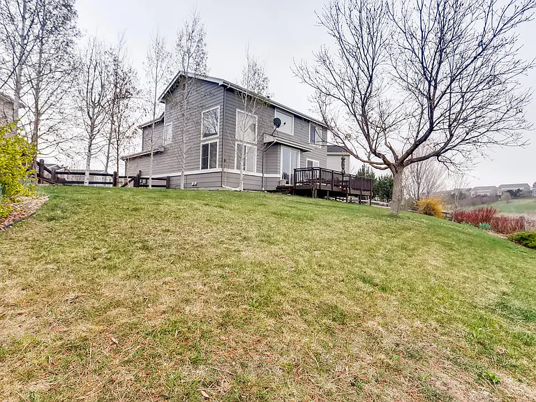 large backyard with deck and view of open space and walking paths