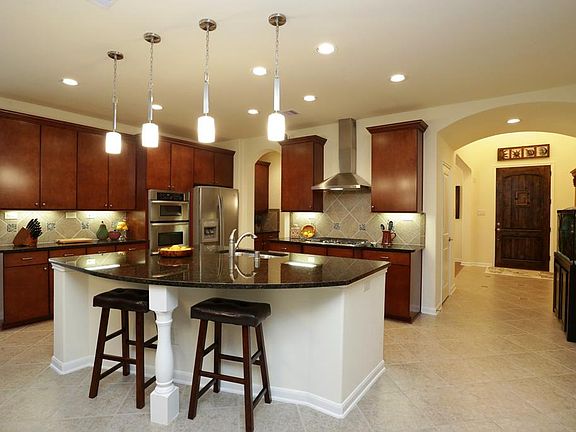 Keep an eye on everything  and enjoy your guests when entertaining from this island kitchen