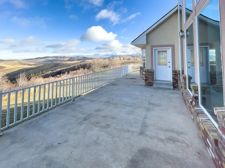 with access from the kitchen and the primary bedroom, this large concrete deck has tons of potential for entertaining or simply relaxing and watching the sun set.
