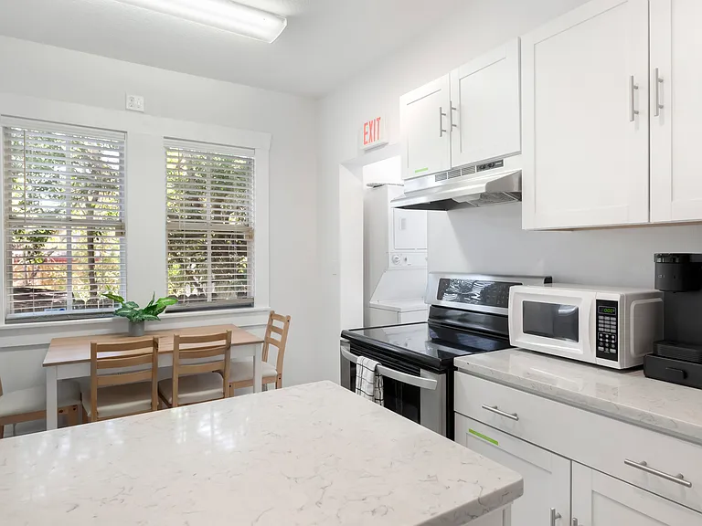 kitchen with electric stove top, oven, microwave, keurig machine