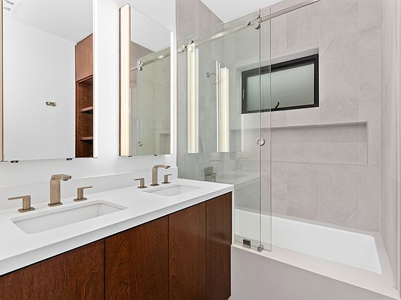 Bathroom #1 with dual sinks and spa shower/bath.