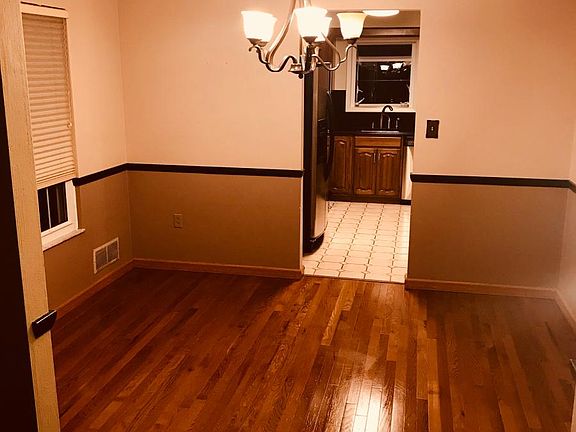 Dining room with chair rail and updated chandelier.
