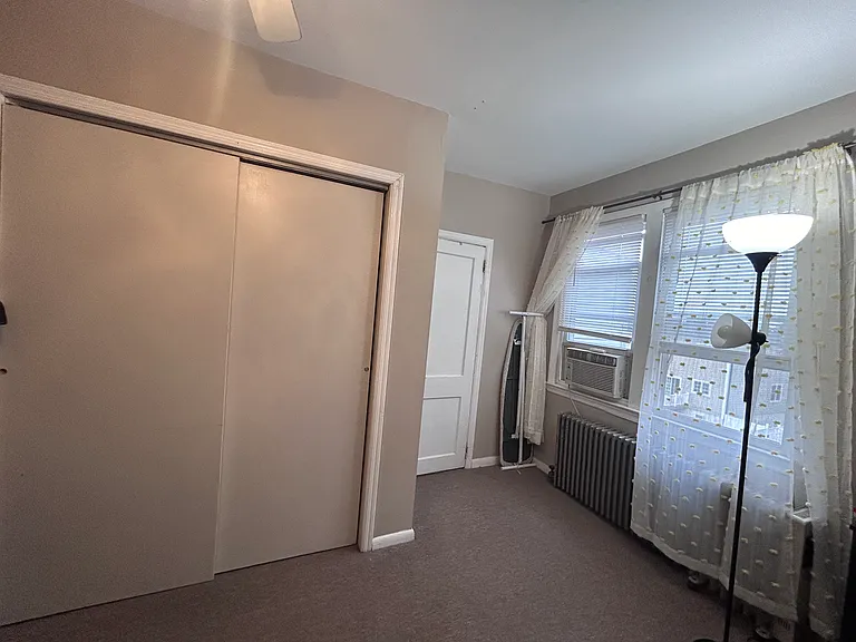 Bedroom Closet leading the the Single Bathroom with Shower