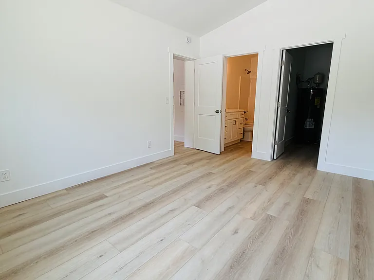 Primary bedroom with walk in closet and private full bathroom