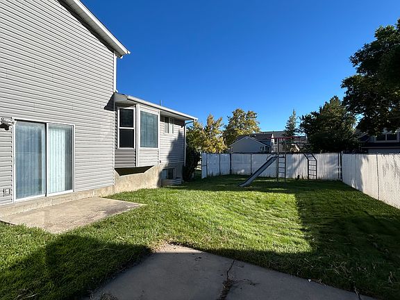 Fenced backyard with patio and playground