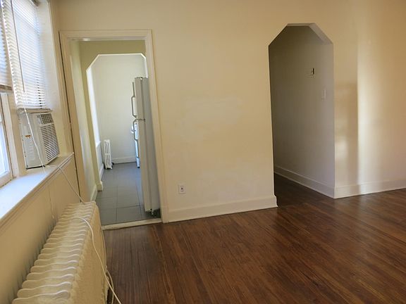 In the 2nd room, looking toward the entrances to the kitchen and bathroom.