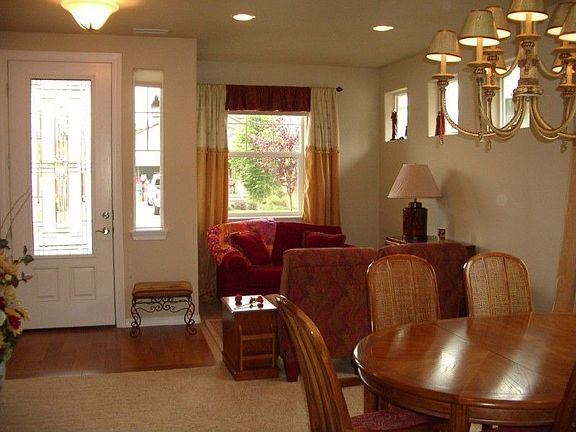 Enter through a beautiful leaded glass door with oak hardwood floors to a living room/ dining room c