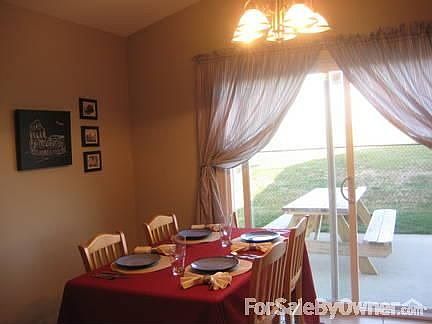 Dining Area : The dining area has a sliding glass door to the fenced-in backyard.