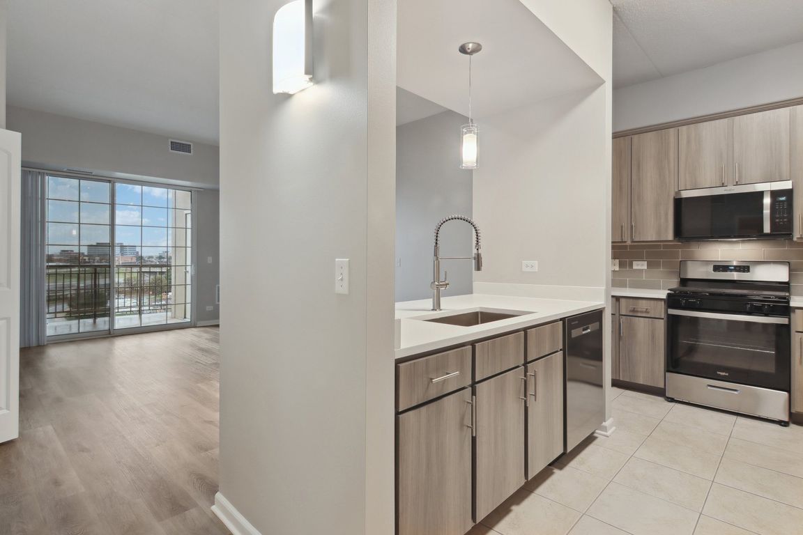 Modern kitchen with sleek countertops and lighting