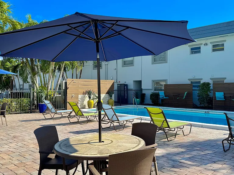 Enjoy poolside dining under the shade, with a serene atmosphere.